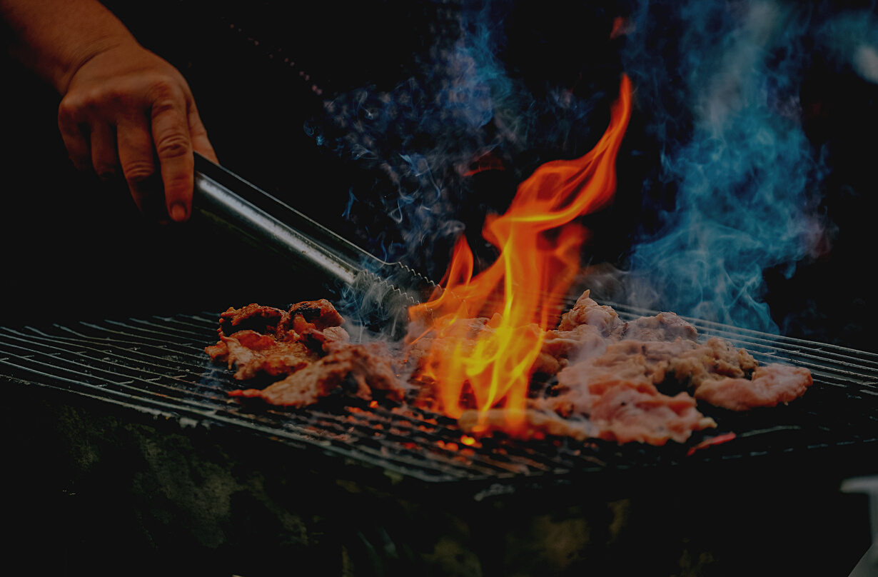 Close-Up Photo of Man Cooking Meat